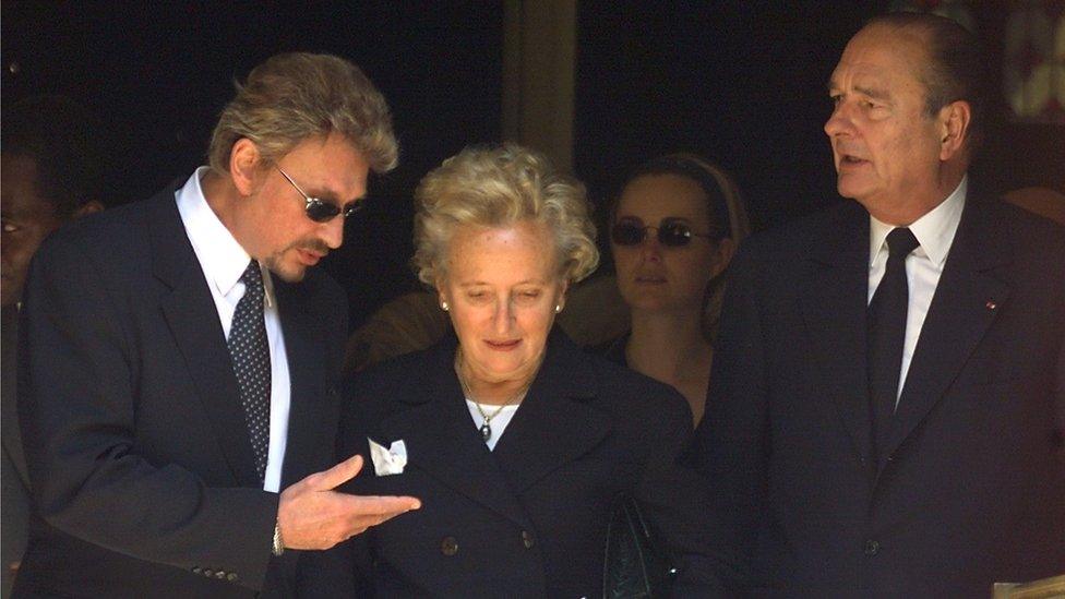 A file photo taken on June 25, 1999 in Paris shows French president Jacques Chirac (R), his wife Bernadette and French singer Johnny Hallyday