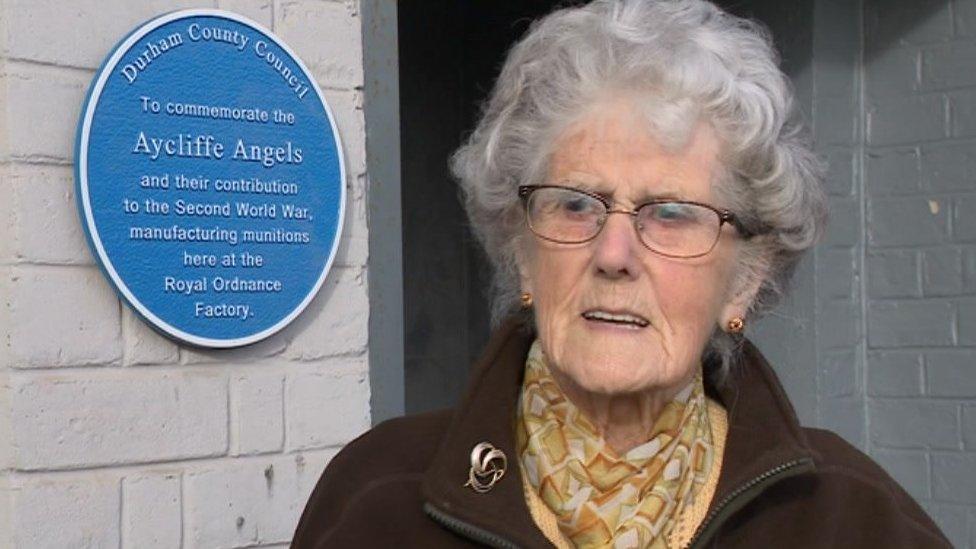 Muriel Scott next to the plaque