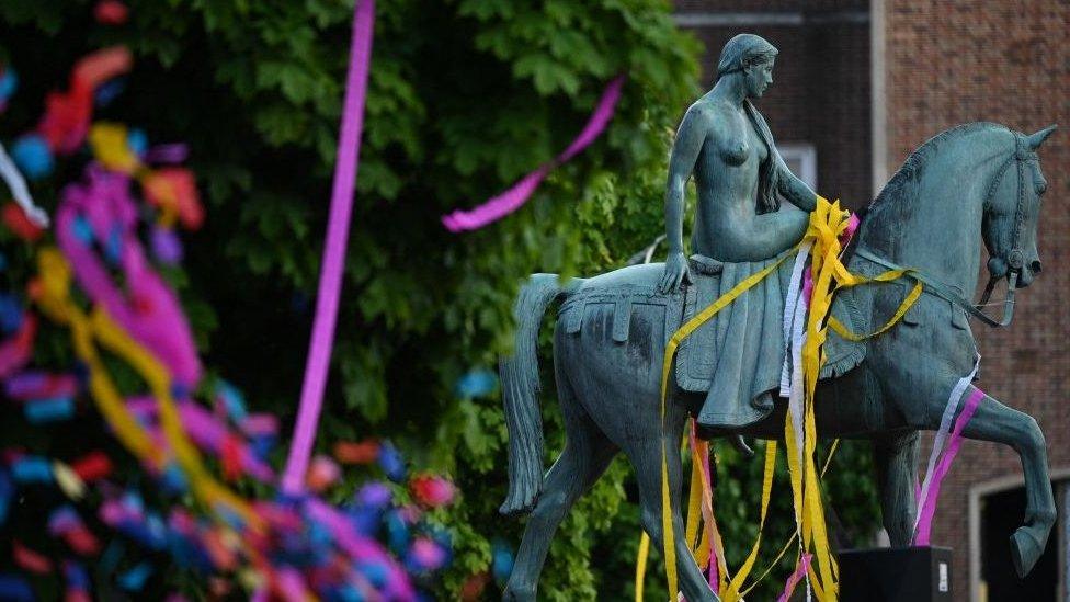 The statue of Lady Godiva is covered in confetti