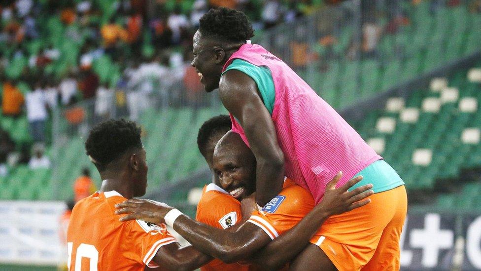 Footballers celebrating with one on another's shoulders