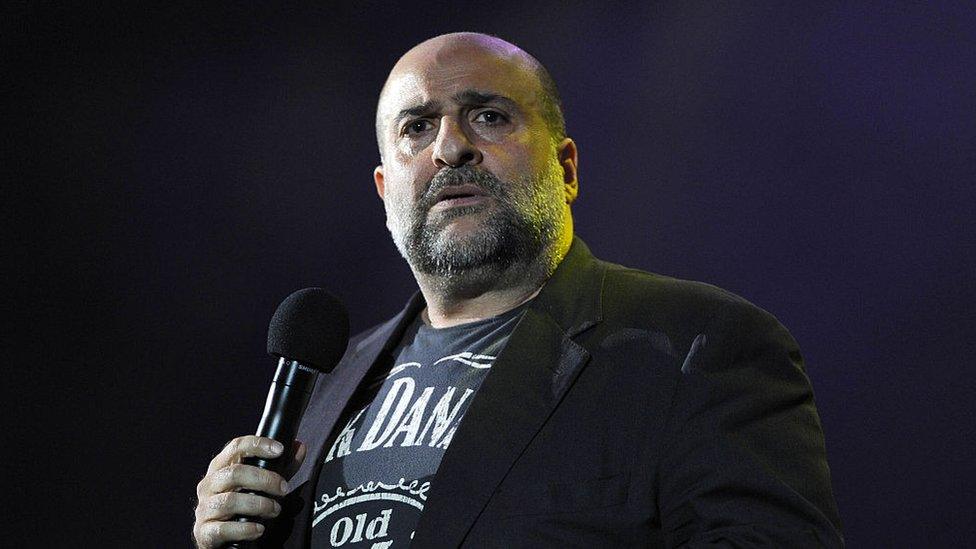 Omid Djalili performing on stage