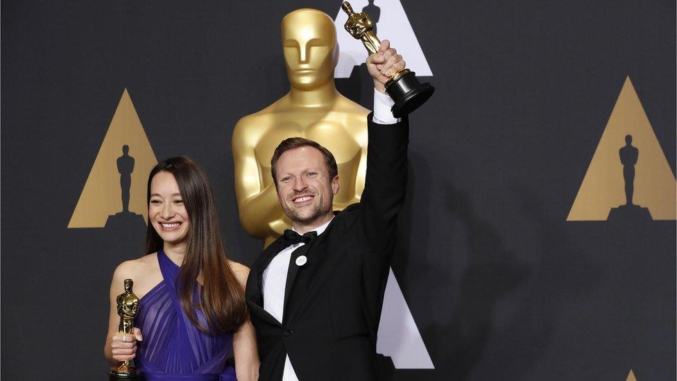 Producer Joanna Natasegara and director Orlando von Einsiedel after the awards with their Oscars