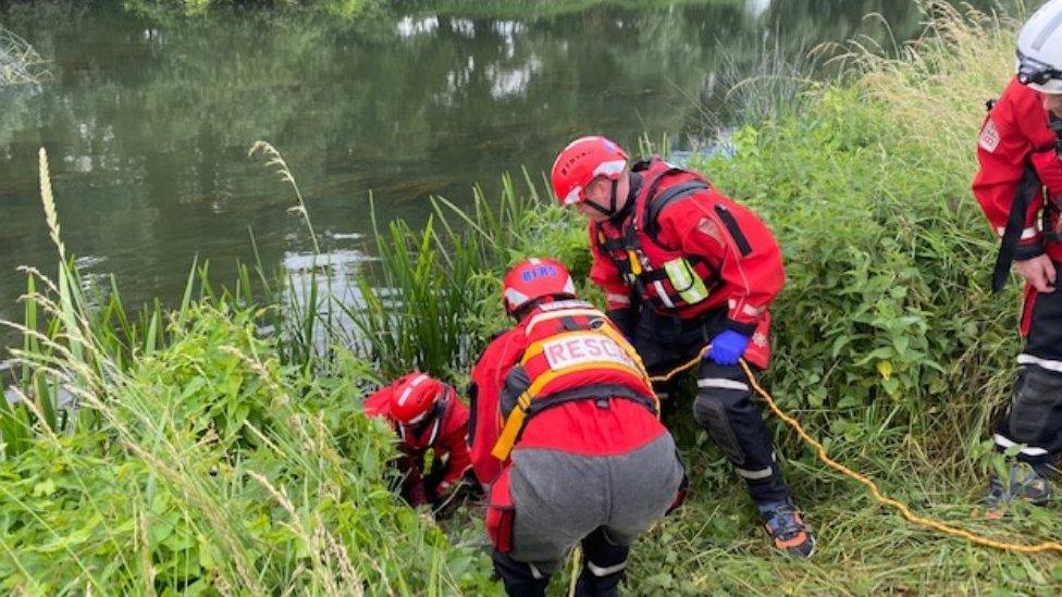 Woman being rescued from river