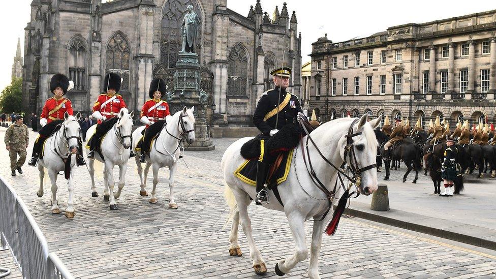 Exterior of St Giles showing men on horseback