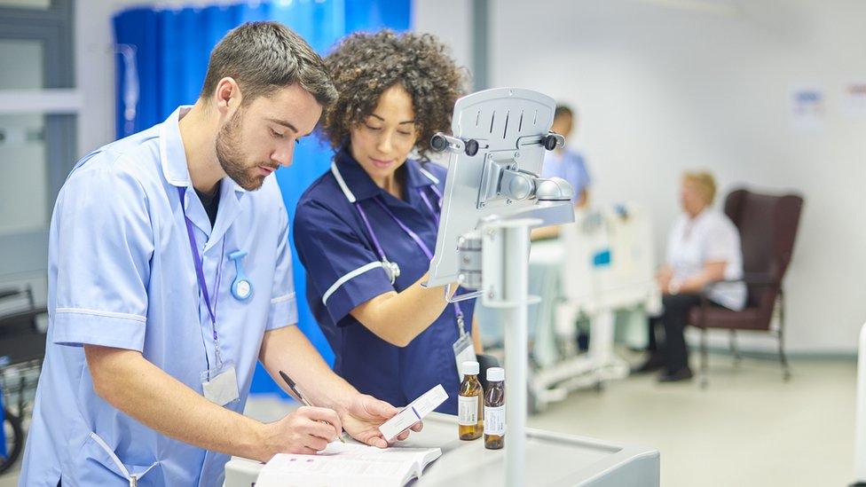 nurses filling in prescription