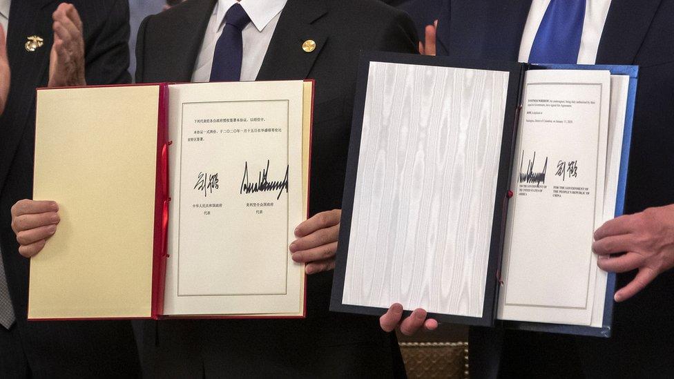 Chinese vice premier Liu He (L) and US president Donald J. Trump (R) sign a partial trade deal