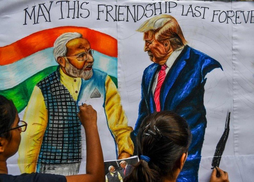 Students paint on canvas faces of US President Donald Trump (R) and India's Prime Minister Narendra Modi, in the street in Mumbai on February 21, 2020, ahead of the visit of US President in India