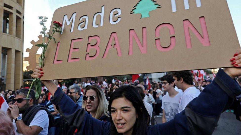 Lebanese demonstrators take part in a civilian Independence Day parade in Beirut's Martyr Square on November 22, 2019,