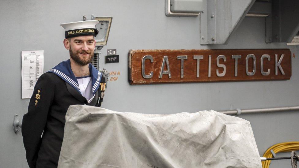 Crew member standing next to Cattistock sign