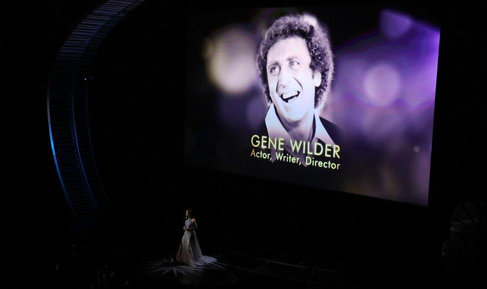 Sara Bareilles performs during the "In Memoriam" segment with an image of the late Gene Wilde