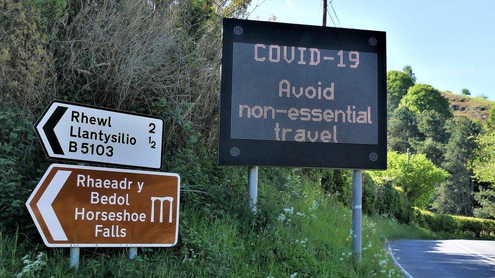 A road sign telling people to avoid essential travel