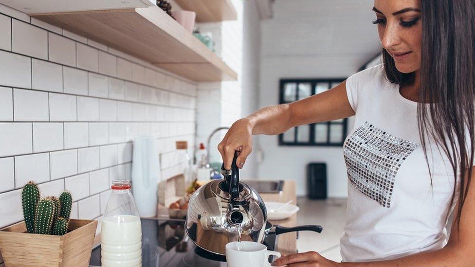 A woman making a cup of tea