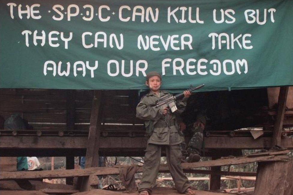 A young Karen soldier poses with a gun in January 2000, to celebrate the 51st Anniversary of the KNU's Revolutionary Day