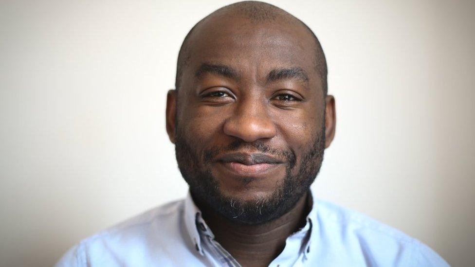 Headshot of Poku Osei smiling at the camera