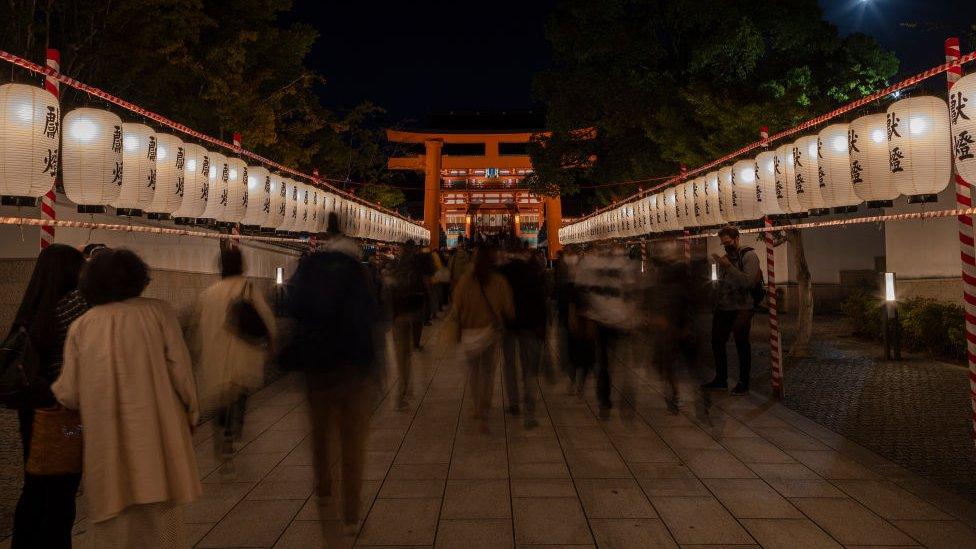 Tourists visit Fushimi Inari-taisha shrine in Kyoto at night