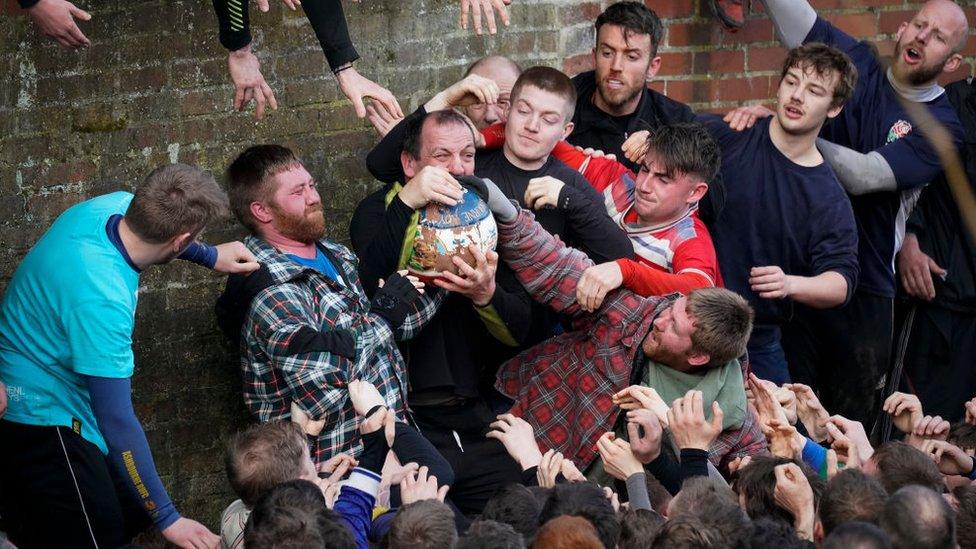 Men grab ball in Ashbourne