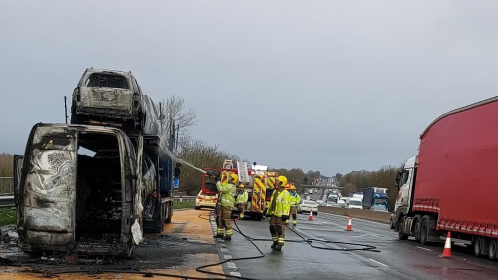 A burnt-out van and transporter on the M6