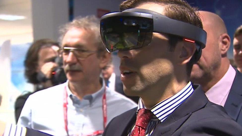 Ken Skates trying virtual reality technology on Deeside