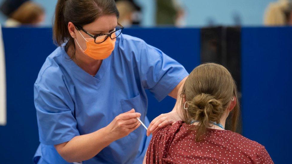 A woman being vaccinated in Cwmbran