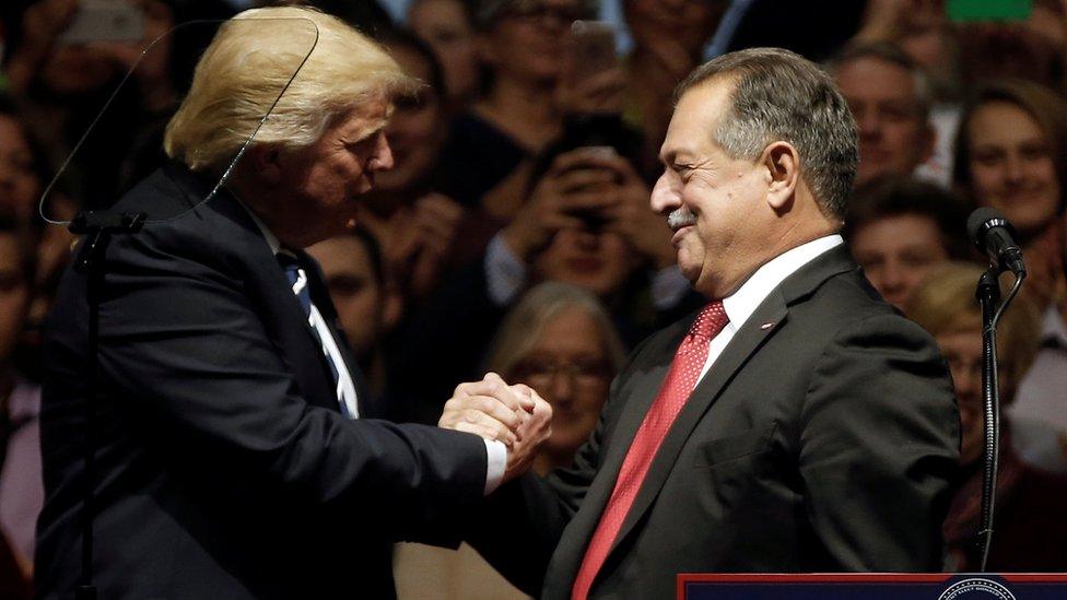 Donald Trump greets Andrew Liveris at a "Thank You USA" tour rally in Grand Rapids, Michigan, December 9, 2016