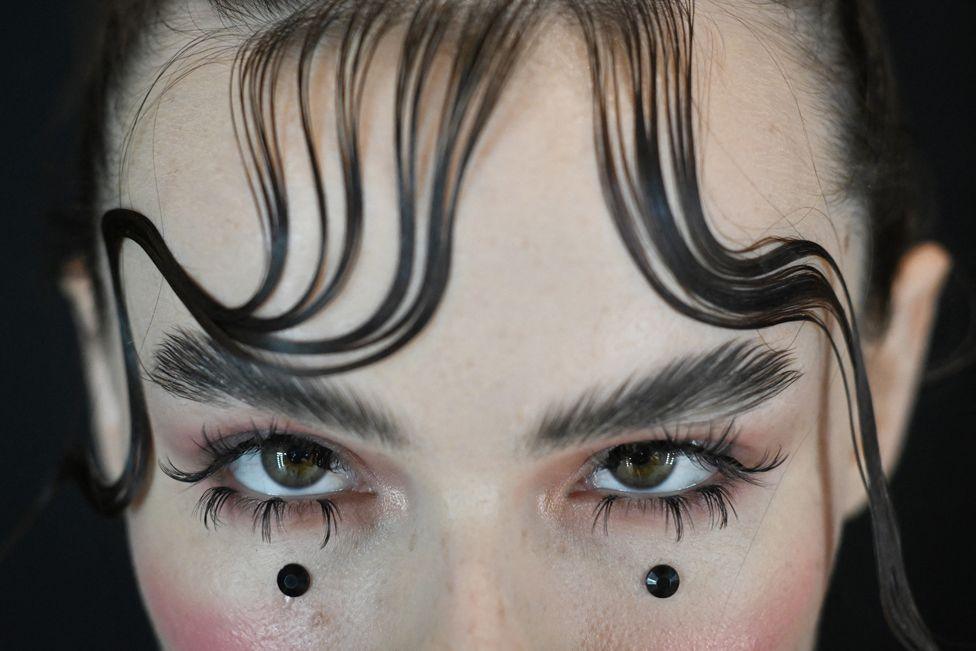 A model prepares backstage for the show of the Russian brand Barbino Maison during the Moscow Fashion Week at the Manezh exhibition hall in Moscow on October 9, 2024. 