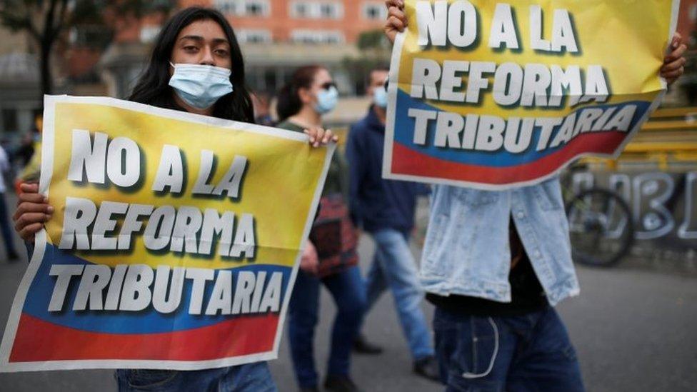 Demonstrators hold banners reading "No to the tax reform" as they take part in a protest against the tax reform of President Ivan Duque"s government in Bogota, Colombia April 28, 2021