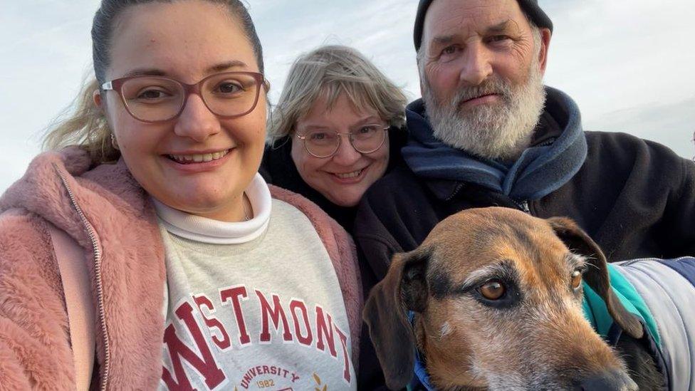 Bethany Rose Hunt, Julia Hunt and Martin Hunt posing with their dog.