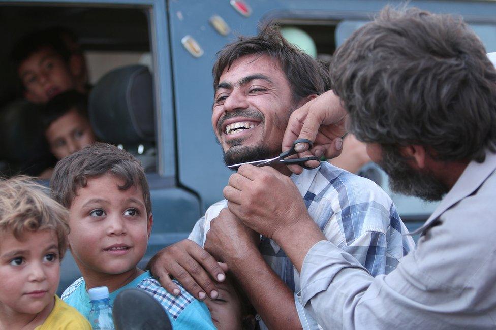 Civilians evacuated from an Islamic State-controlled neighbourhood of Manbij, Syria, 12 August