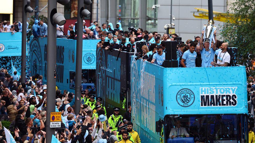 Manchester City's team on bus parading their trophies