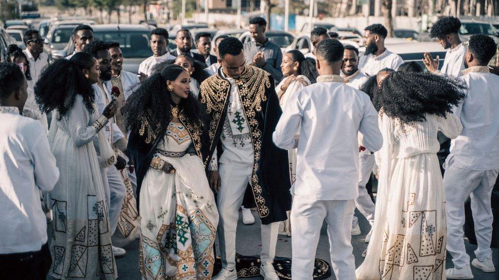 Couples who are getting married dance in the street in the streets of Mekelle, Ethiopia, on May 26, 2024.