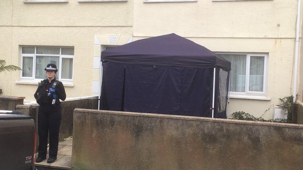 A police officer stood outside a forensics tent which has been placed outside a house on Lakeview Place