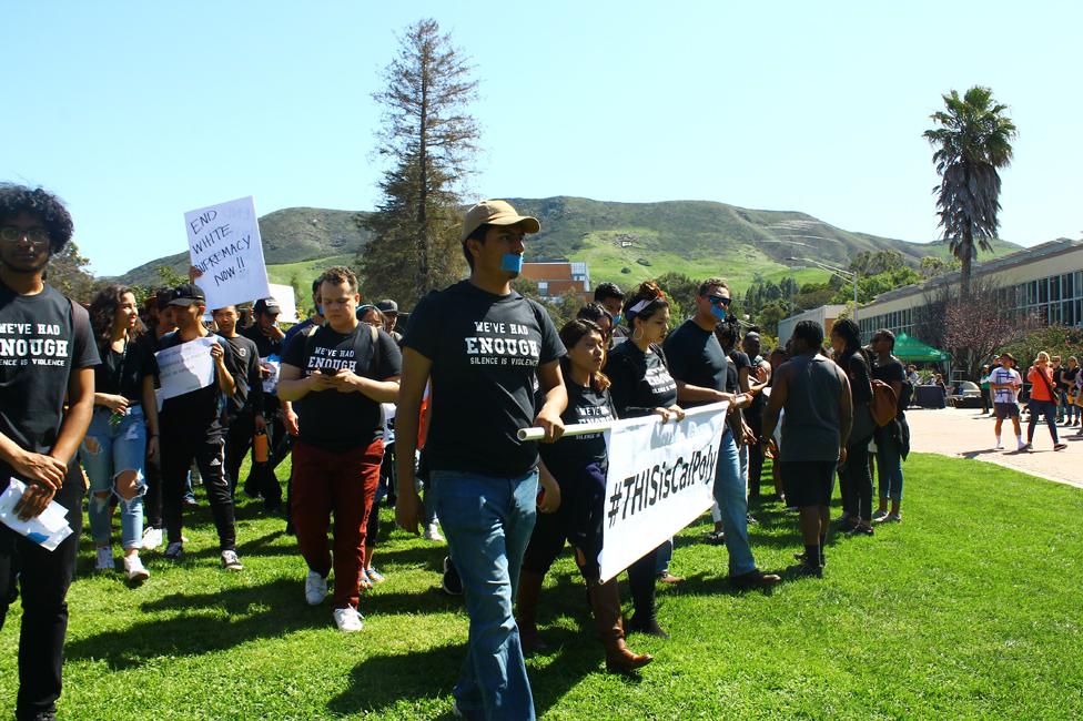 Protest wearing T shirts with the slogan "We've had enough" - some participants have tape over their mouths