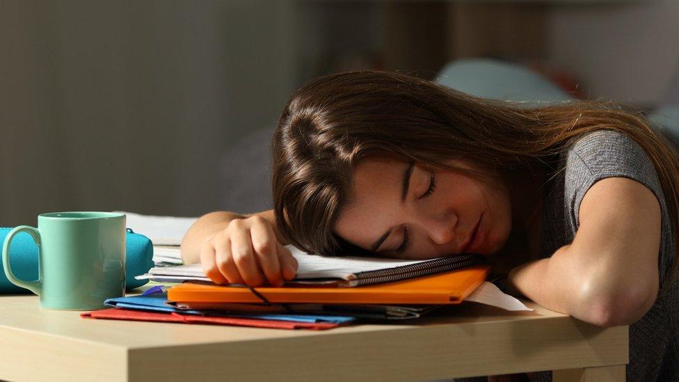 Teenager asleep at desk