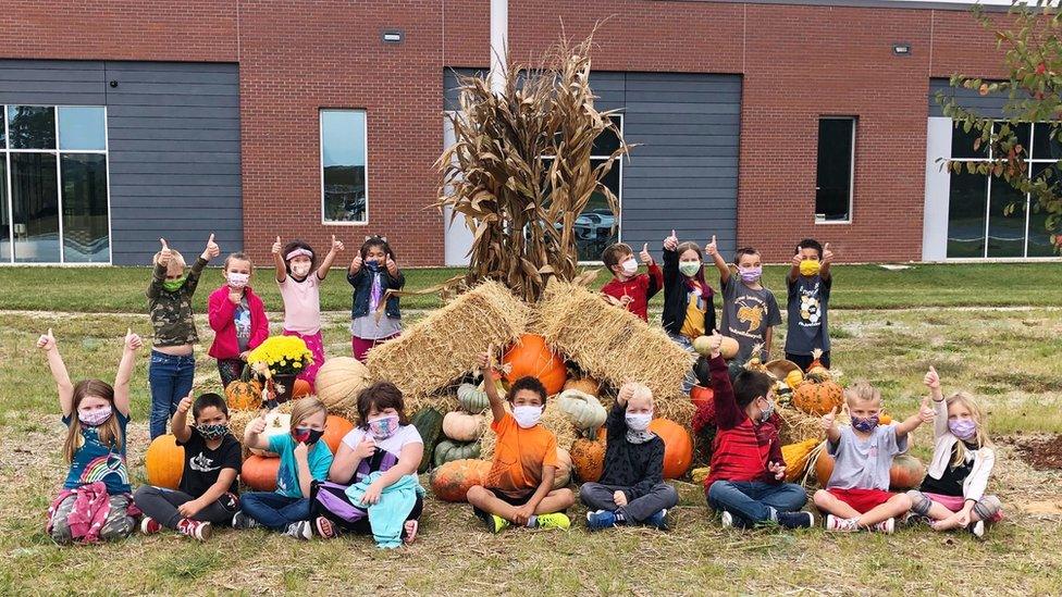 Children in front of their fall display.