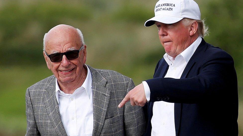 Republican presidential candidate Donald Trump (R) speaks to media mogul Rupert Murdoch as they walk out of Trump International Golf Links in Aberdeen, Scotland, June 25, 2016