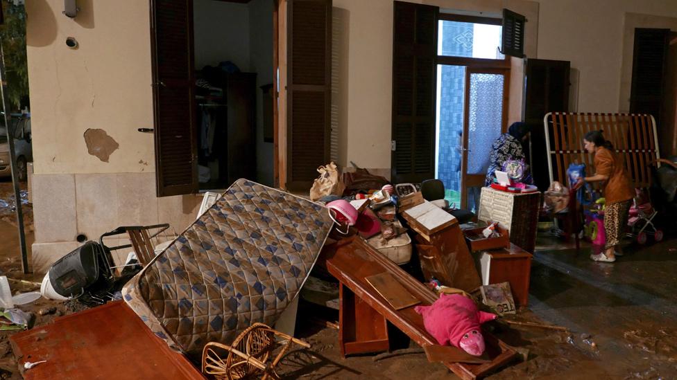 Woman with possessions piled in street, 10 Oct 18