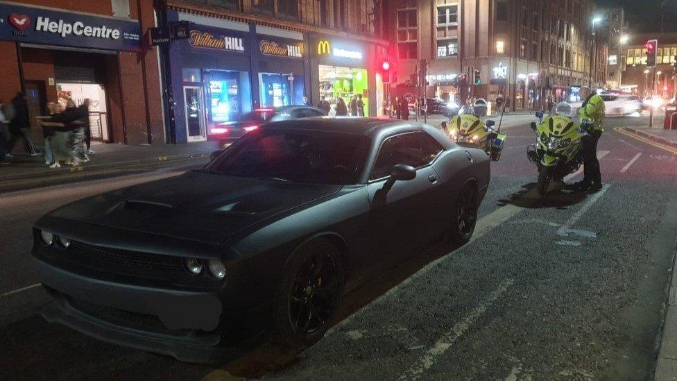 car seized by police on motorbikes