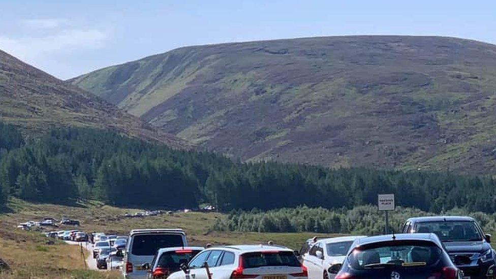 Cars parked at Loch Muick