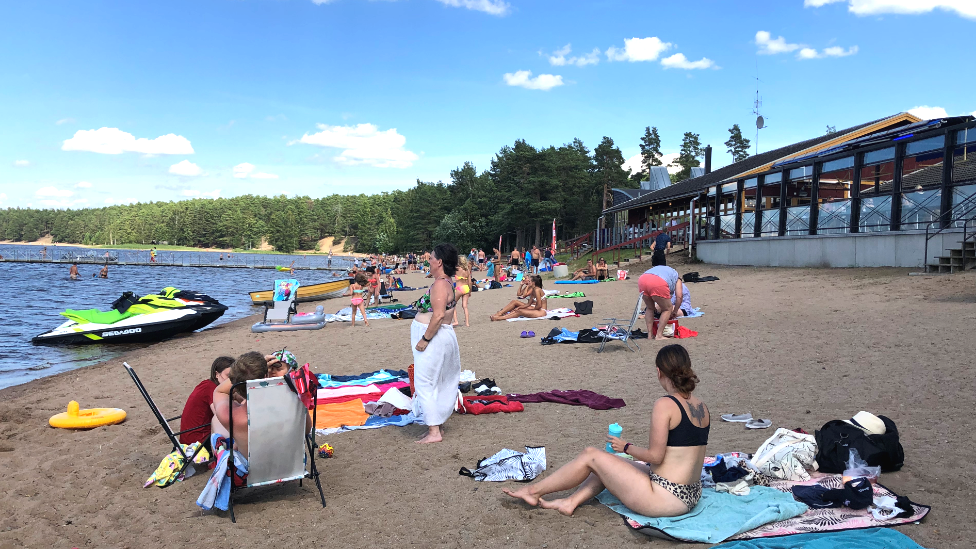 Bathers on the shore of Lake Storsjön in Sweden