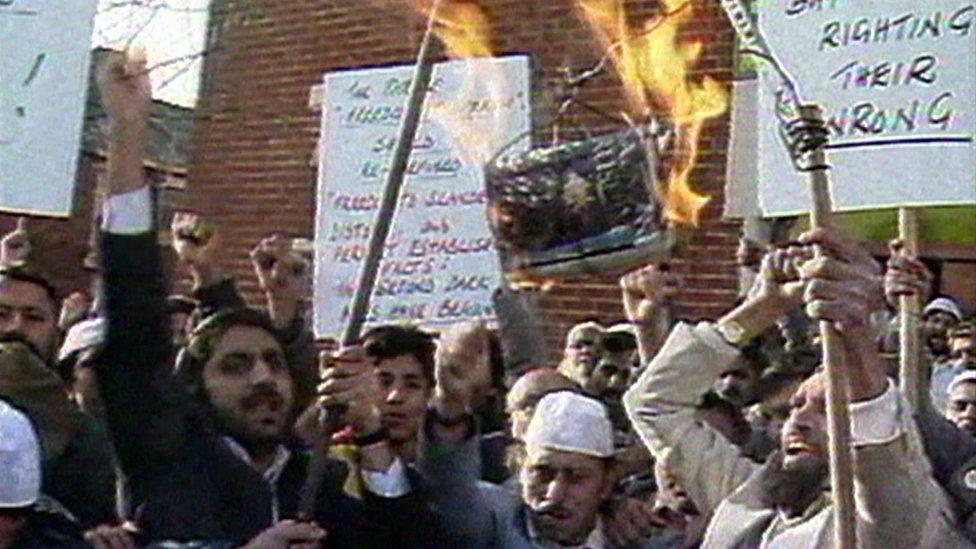 Protesters burn a copy of Salman Rushdie's The Satanic Verses at a protest in Blackburn, 1989