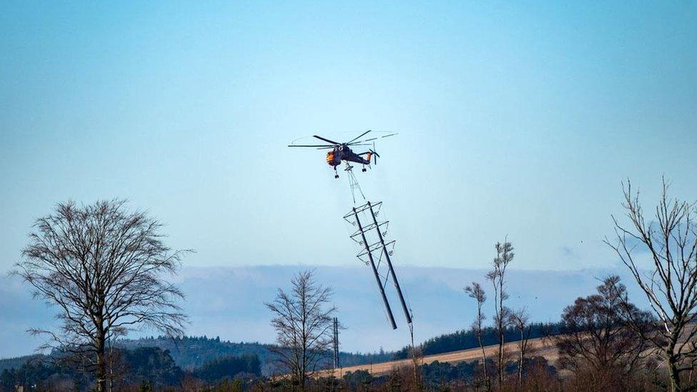 Helicopter and electricity towers