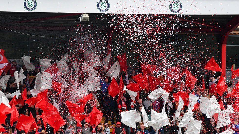 Larne fans celebrate the club winning the Irish League