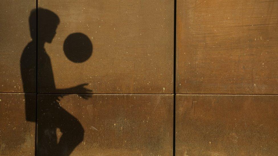 shadow-of-boy-playing-football