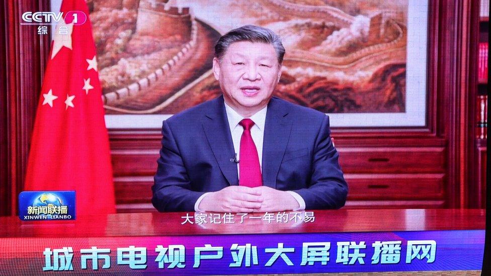 A screen shows Chinese President Xi Jinping delivering a New Year address to ring in 2024, in Beijing, China, 31 December 2023.