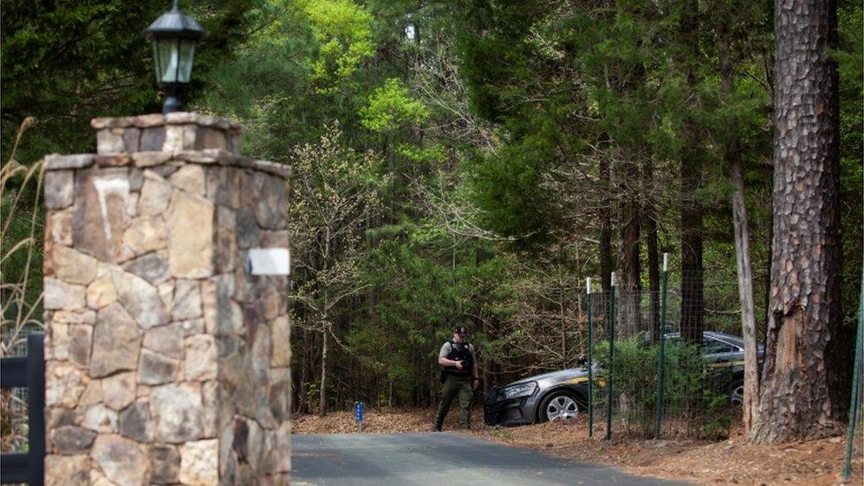 Sheriff officials guard the home where the shooting occured