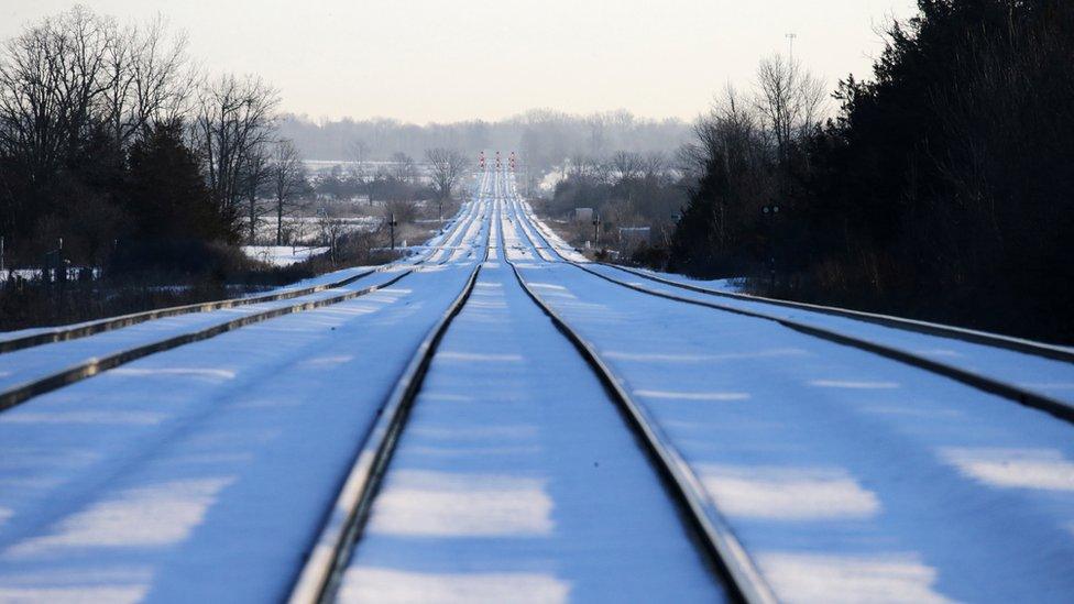 Train tracks lead towards the camp of First Nations members at a railway crossing