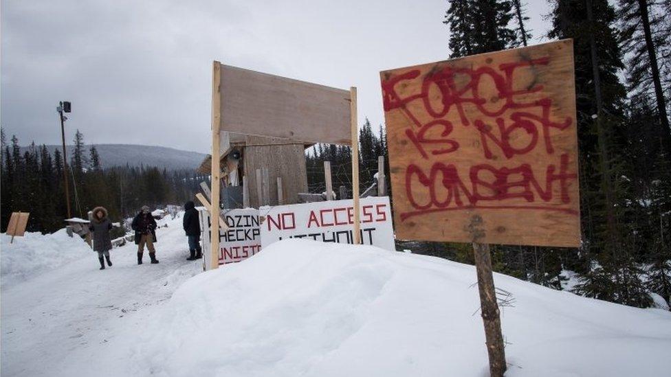 A checkpoint is seen at a bridge leading to the Unist"ot"en camp on a remote logging road.