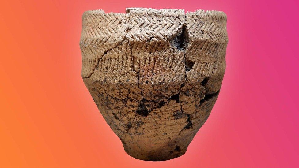 A food vessel dating back to the Bronze Age over an orange and pink background.