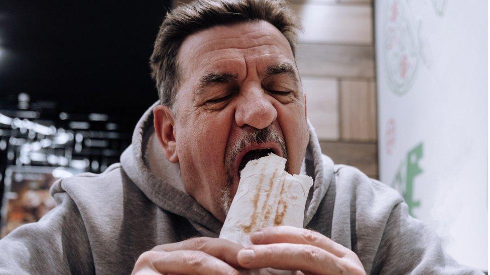 man eating a kebab