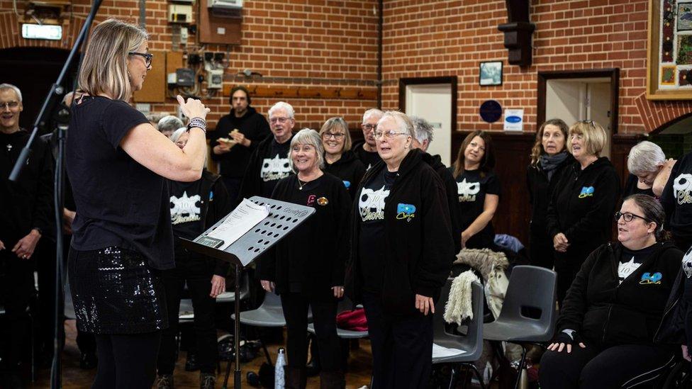 Yula Andrews (left) directing the Pop Chorus, choir